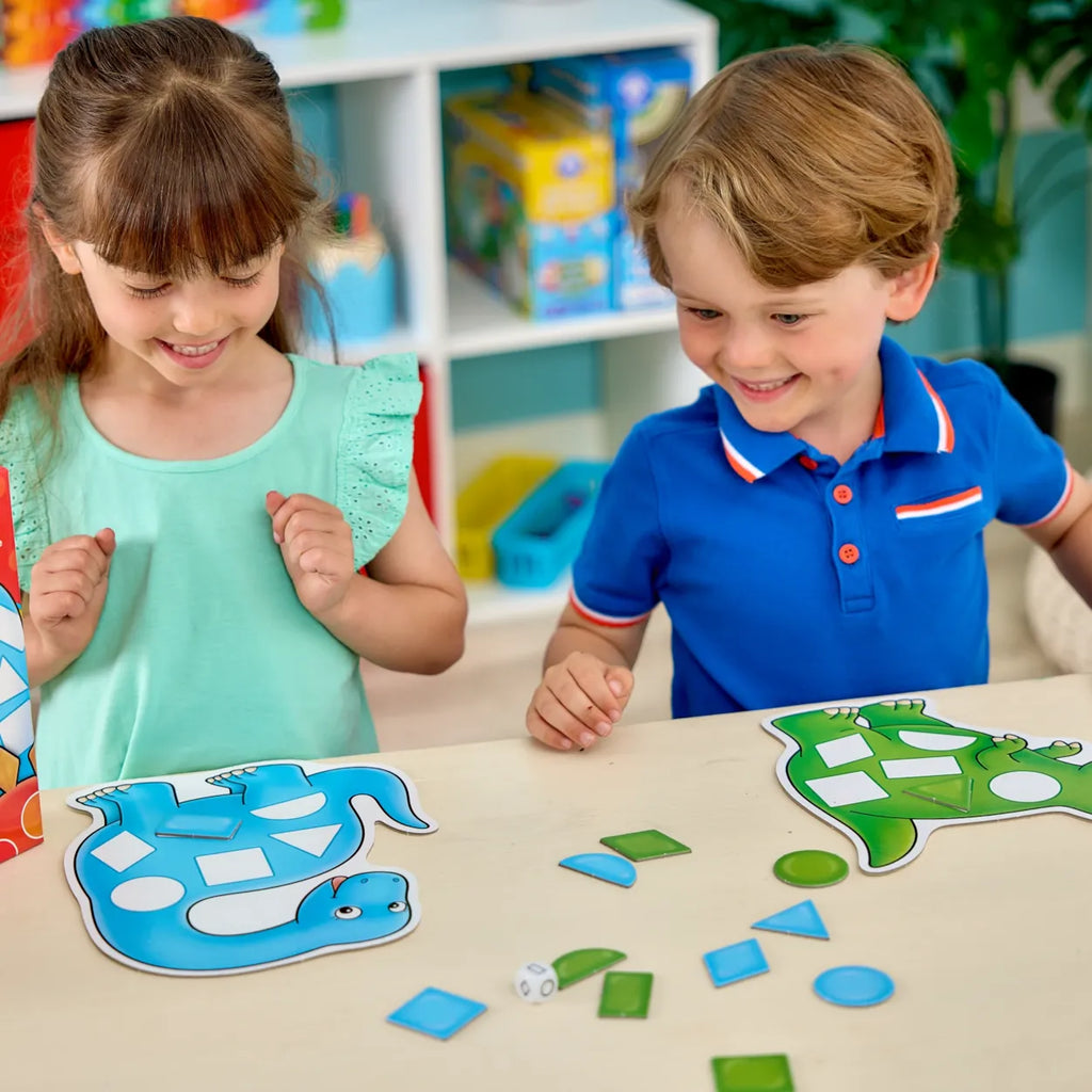 Two children playing with a turtle shape sorting game at a table.