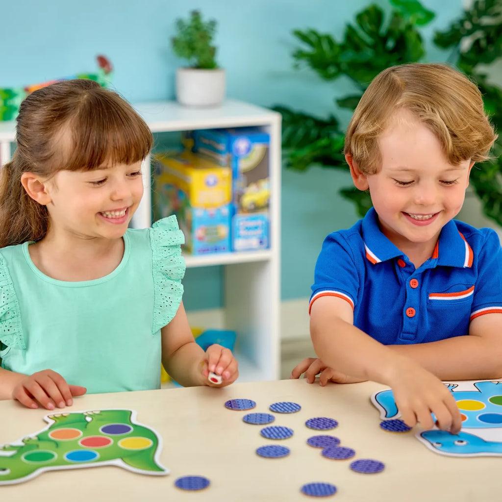 Two children playing with educational toys at a table in a classroom setting.