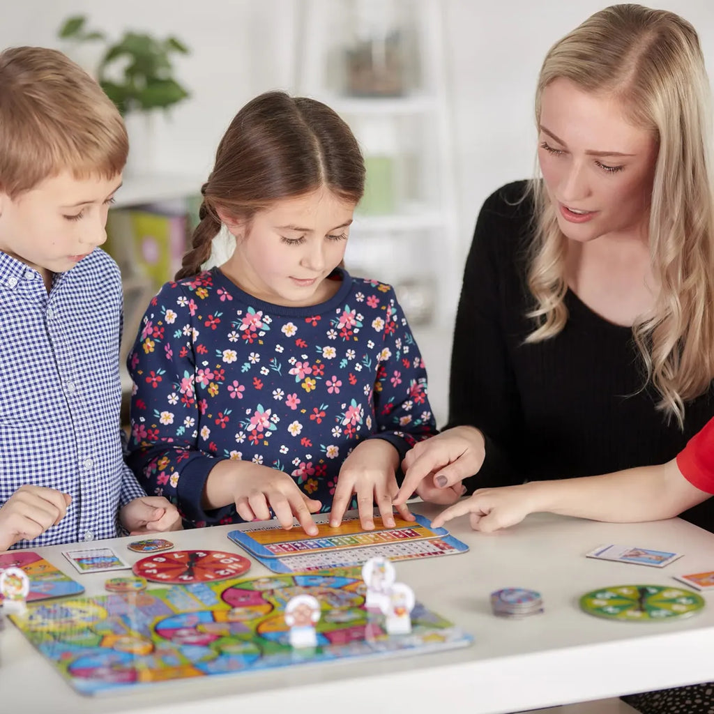 Woman and two children playing a board game together